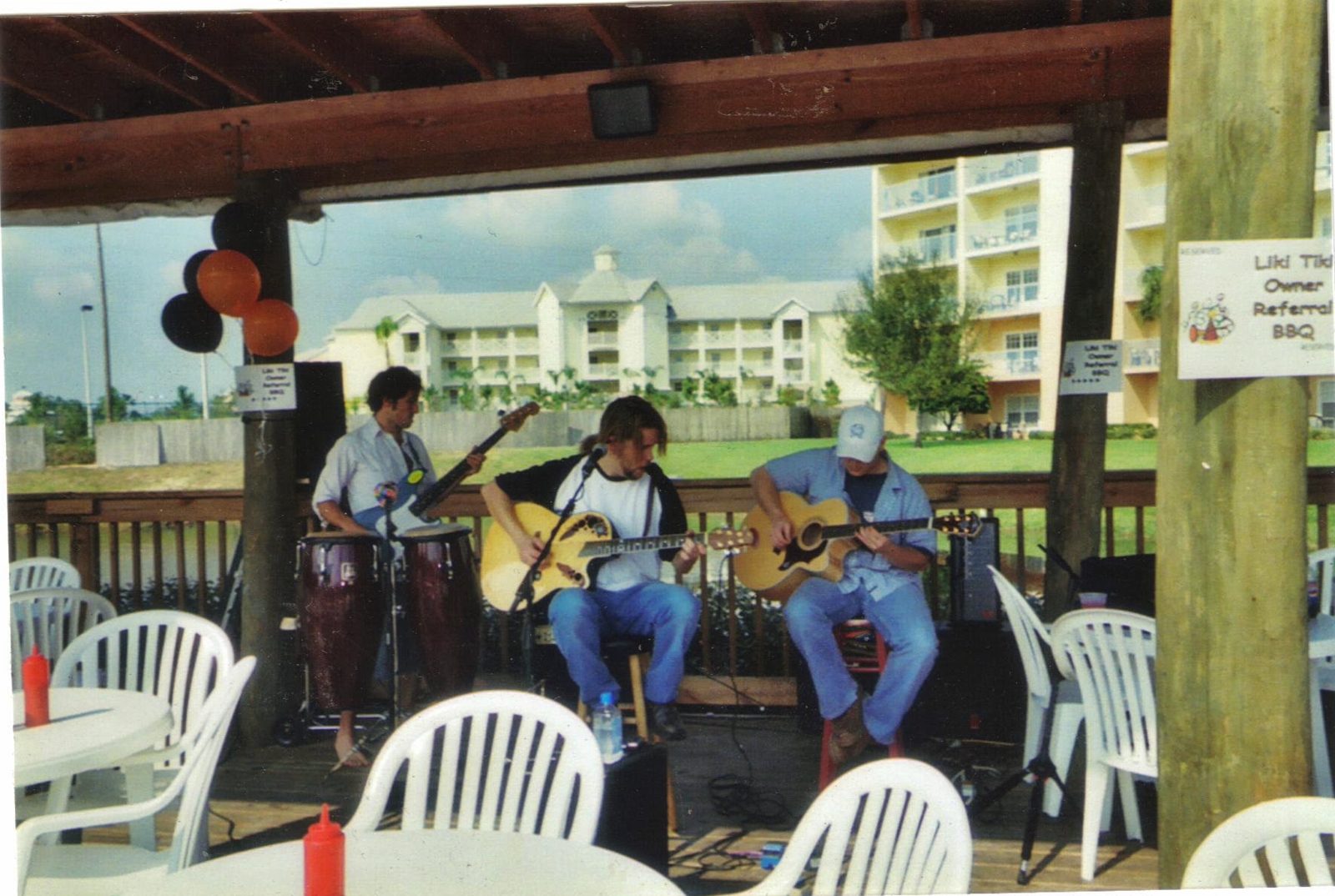 V playing acoustic guitar with his band in Florida